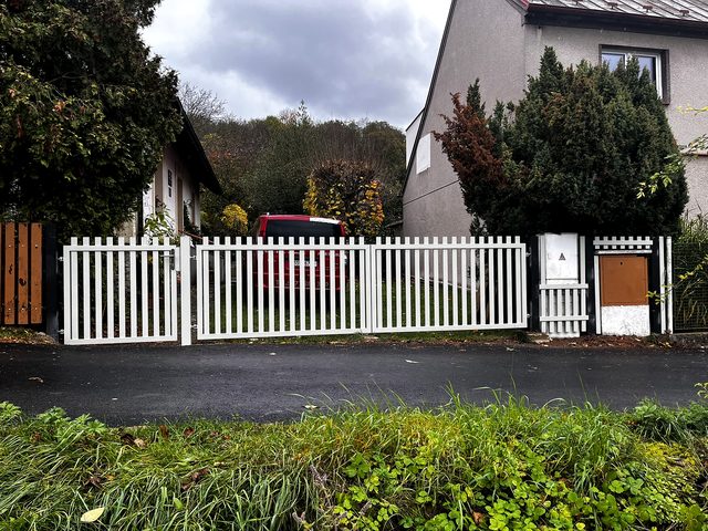 White swing gate and fence for a family house